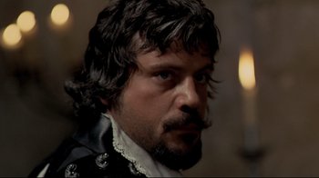 Movie still from “The Four Musketeers: Milady's Revenge” (1974), directed by Richard Lester – A person with a beard; Close Up shot, Over the shoulder angle
