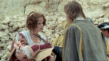 Movie still from “The Four Musketeers: Milady's Revenge” (1974), directed by Richard Lester – A woman and a man in medieval garb talking to each other; Medium shot, Over the shoulder angle