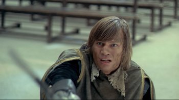 Movie still from “The Four Musketeers: Milady's Revenge” (1974), directed by Richard Lester – A man with long brown hair wearing a brown shirt; Close Up shot, High angle