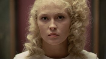 Movie still from “The Four Musketeers: Milady's Revenge” (1974), directed by Richard Lester – A person with curly hair; Close Up shot, Overhead angle