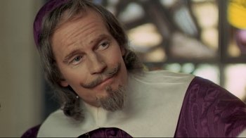Movie still from “The Four Musketeers: Milady's Revenge” (1974), directed by Richard Lester – A man with a beard and mustache; Close Up shot, Over the shoulder angle