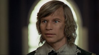 Movie still from “The Four Musketeers: Milady's Revenge” (1974), directed by Richard Lester – A person with long blonde hair; Close Up shot, Over the shoulder angle