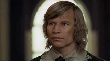 Movie still from “The Four Musketeers: Milady's Revenge” (1974), directed by Richard Lester – A person with long blonde hair; Close Up shot, Over the shoulder angle