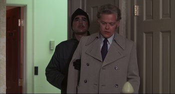 Movie still from “The Friends of Eddie Coyle” (1973), directed by Peter Yates – A man in a suit and a man in a hat; Medium shot, Over the shoulder angle