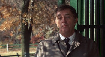 Movie still from “The Friends of Eddie Coyle” (1973), directed by Peter Yates – A person wearing a coat and tie; Close Up shot, Low angle