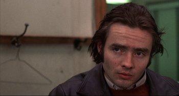 Movie still from “The Friends of Eddie Coyle” (1973), directed by Peter Yates – A person with long hair; Close Up shot, Low angle