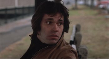 Movie still from “The Friends of Eddie Coyle” (1973), directed by Peter Yates – A person with long hair; Close Up shot, Low angle