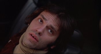 Movie still from “The Friends of Eddie Coyle” (1973), directed by Peter Yates – A person with long dark hair; Close Up shot, Low angle