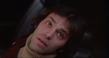 Movie still from “The Friends of Eddie Coyle” (1973), directed by Peter Yates – A person with long black hair; Close Up shot, Low angle