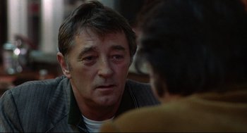 Movie still from “The Friends of Eddie Coyle” (1973), directed by Peter Yates – A person talking to another person; Close Up shot, Over the shoulder angle