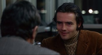 Movie still from “The Friends of Eddie Coyle” (1973), directed by Peter Yates – A man in a brown jacket is talking to another man; Close Up shot, Over the shoulder angle