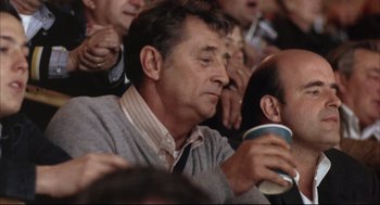 Movie still from “The Friends of Eddie Coyle” (1973), directed by Peter Yates – A person drinking a cup of coffee; Close Up shot, Over the shoulder angle