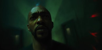 Movie still from “Altered Carbon” (2018), created by Laeta Kalogridis – A man's face in a dark room; Close Up shot, Low angle