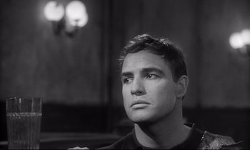 Movie still from “The Fugitive Kind” (1960), directed by Sidney Lumet – Black and white photograph of a man looking up; Close Up shot, Over the shoulder angle