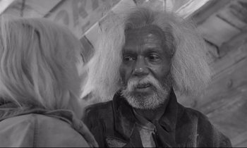 Movie still from “The Fugitive Kind” (1960), directed by Sidney Lumet – An old man with a long white beard and white hair; Close Up shot, Over the shoulder angle