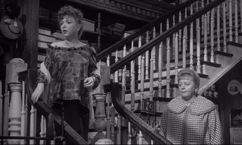 Movie still from “The Fugitive Kind” (1960), directed by Sidney Lumet – A woman standing on the stairs next to another woman; Medium shot, Low angle