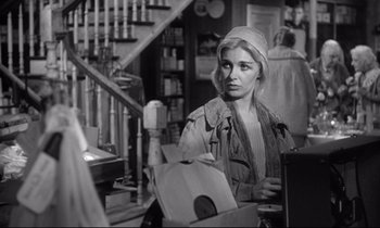 Movie still from “The Fugitive Kind” (1960), directed by Sidney Lumet – A black - and - white photo of a woman looking at the camera; Medium shot, Over the shoulder angle