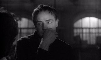 Movie still from “The Fugitive Kind” (1960), directed by Sidney Lumet – Black and white photograph of a man with his hand under his chin; Close Up shot, Over the shoulder angle