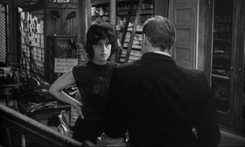 Movie still from “The Fugitive Kind” (1960), directed by Sidney Lumet – A man and a woman are talking in a store; Medium shot, Over the shoulder angle