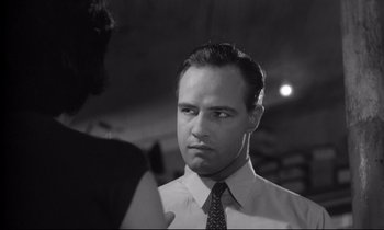 Movie still from “The Fugitive Kind” (1960), directed by Sidney Lumet – Black and white photograph of a man in a tie; Close Up shot, Over the shoulder angle