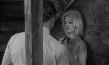 Movie still from “The Fugitive Kind” (1960), directed by Sidney Lumet – A man and a woman are looking at each other; Medium shot, Over the shoulder angle