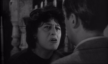 Movie still from “The Fugitive Kind” (1960), directed by Sidney Lumet – An older woman is crying in front of a young man; Close Up shot, Over the shoulder angle
