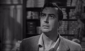 Movie still from “The Fugitive Kind” (1960), directed by Sidney Lumet – A man in a suit looking up at the sky; Close Up shot, Low angle