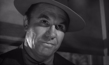 Movie still from “The Fugitive Kind” (1960), directed by Sidney Lumet – A black and white photo of a man wearing a hat; Close Up shot, Low angle