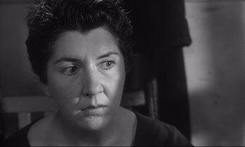 Movie still from “The Fugitive Kind” (1960), directed by Sidney Lumet – Black and white photograph of a woman looking at the camera; Close Up shot, High angle