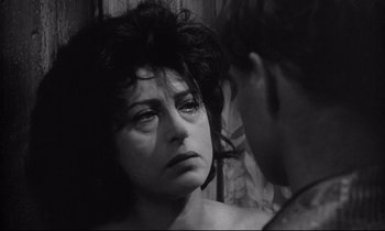 Movie still from “The Fugitive Kind” (1960), directed by Sidney Lumet – A black - and - white photo of a woman looking at a man; Close Up shot, Over the shoulder angle