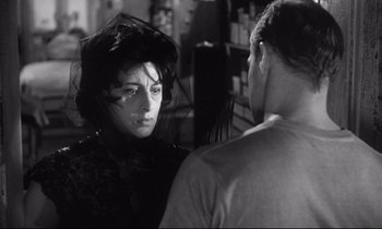 Movie still from “The Fugitive Kind” (1960), directed by Sidney Lumet – A man and a woman are talking in a store; Close Up shot, Over the shoulder angle