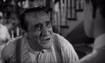 Movie still from “The Fugitive Kind” (1960), directed by Sidney Lumet – An older man in a dress shirt and tie looking angry; Close Up shot, Low angle