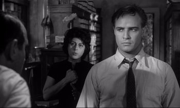 Movie still from “The Fugitive Kind” (1960), directed by Sidney Lumet – A man and a woman standing next to each other in a room; Medium shot, Low angle