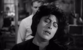 Movie still from “The Fugitive Kind” (1960), directed by Sidney Lumet – A woman with her eyes closed in front of a man; Close Up shot, High angle