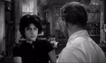 Movie still from “The Fugitive Kind” (1960), directed by Sidney Lumet – A woman talking to a man in front of a counter; Close Up shot, Over the shoulder angle