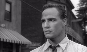 Movie still from “The Fugitive Kind” (1960), directed by Sidney Lumet – Black and white photograph of a man in a shirt and tie; Close Up shot, Low angle