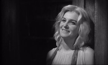 Movie still from “The Fugitive Kind” (1960), directed by Sidney Lumet – Black and white photograph of a woman smiling for the camera; Close Up shot, Low angle