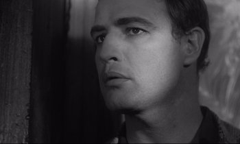 Movie still from “The Fugitive Kind” (1960), directed by Sidney Lumet – Black and white photograph of a man looking into the distance; Close Up shot, Low angle