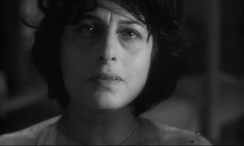 Movie still from “The Fugitive Kind” (1960), directed by Sidney Lumet – Black and white photograph of a woman looking sad; Close Up shot, Low angle