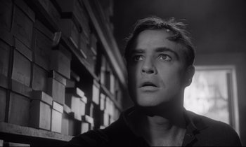 Movie still from “The Fugitive Kind” (1960), directed by Sidney Lumet – Black and white photograph of a man looking up; Close Up shot, Low angle