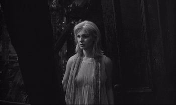 Movie still from “The Fugitive Kind” (1960), directed by Sidney Lumet – A black and white photo of a woman in a dress; Medium shot, Over the shoulder angle