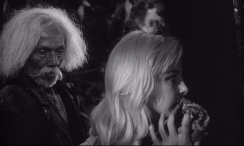 Movie still from “The Fugitive Kind” (1960), directed by Sidney Lumet – An old man and a young woman eating a piece of food; Close Up shot, Over the shoulder angle