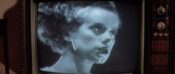 Movie still from “The Funhouse” (1981), directed by Tobe Hooper – An old photo of a woman's face in black and white; Extreme Close Up shot, Low angle