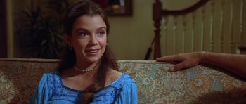 Movie still from “The Funhouse” (1981), directed by Tobe Hooper – A woman sitting on a chair with a hand touching her shoulder; Close Up shot, Over the shoulder angle