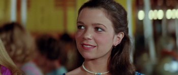 Movie still from “The Funhouse” (1981), directed by Tobe Hooper – A person wearing a necklace; Close Up shot, Low angle