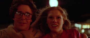 Movie still from “The Funhouse” (1981), directed by Tobe Hooper – A woman with long blonde hair is smiling at the camera with another woman; Close Up shot, Low angle
