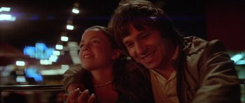 Movie still from “The Funhouse” (1981), directed by Tobe Hooper – A man and a woman smiling for the camera; Close Up shot, Low angle