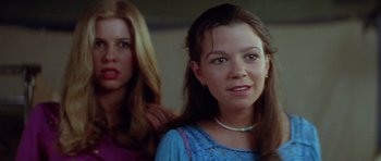 Movie still from “The Funhouse” (1981), directed by Tobe Hooper – Two young women standing next to each other in a room; Close Up shot, Low angle