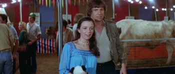 Movie still from “The Funhouse” (1981), directed by Tobe Hooper – A man and a woman standing next to each other; Medium shot, Low angle