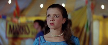Movie still from “The Funhouse” (1981), directed by Tobe Hooper – A young woman wearing a blue dress and a pearl necklace; Close Up shot, Low angle
